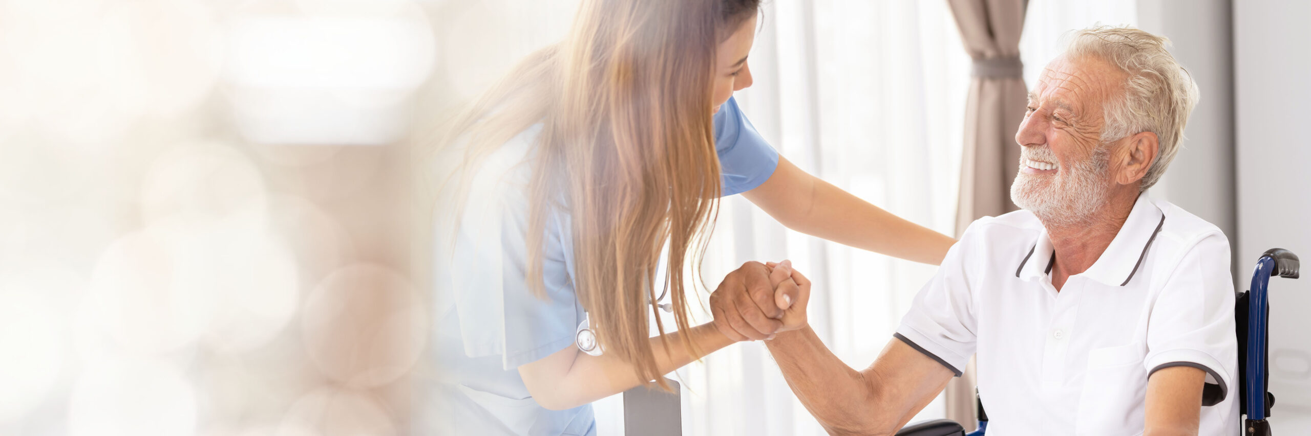 An older patient supported by a member of clinical staff