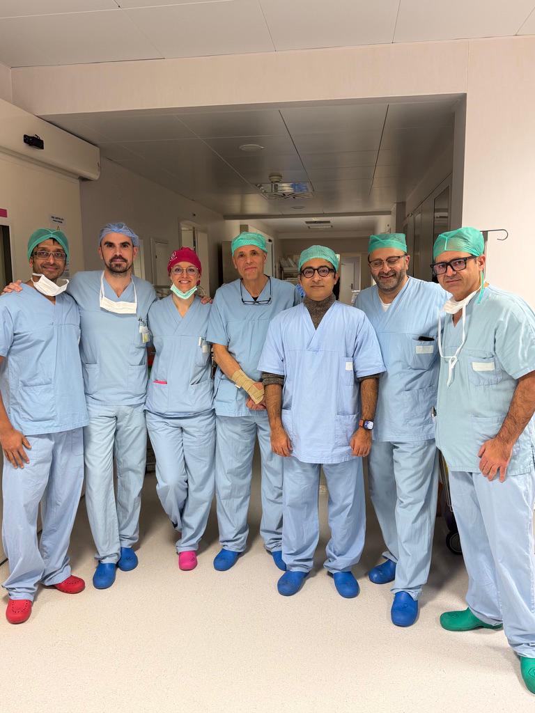 Mr Syed Ali Shahzad with an international robotic surgery team in theatre scrubs