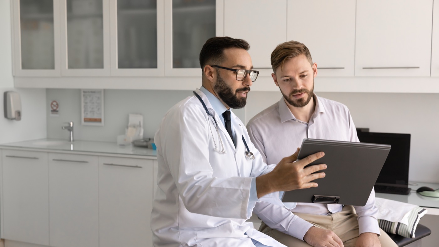 Doctor discussing a health report with a patient in clinic