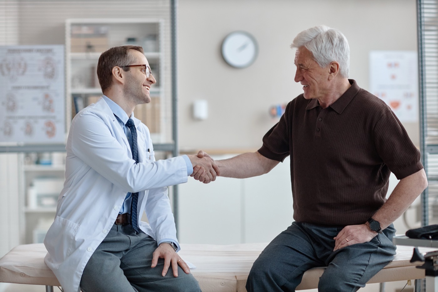 Doctor shaking hands with a senior patient during a urology consultation