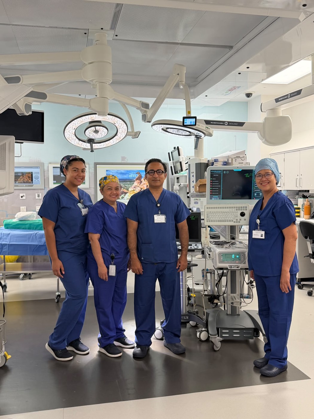 Mr Shahzad and the theatre team with the Aquablation robotic system before a procedure